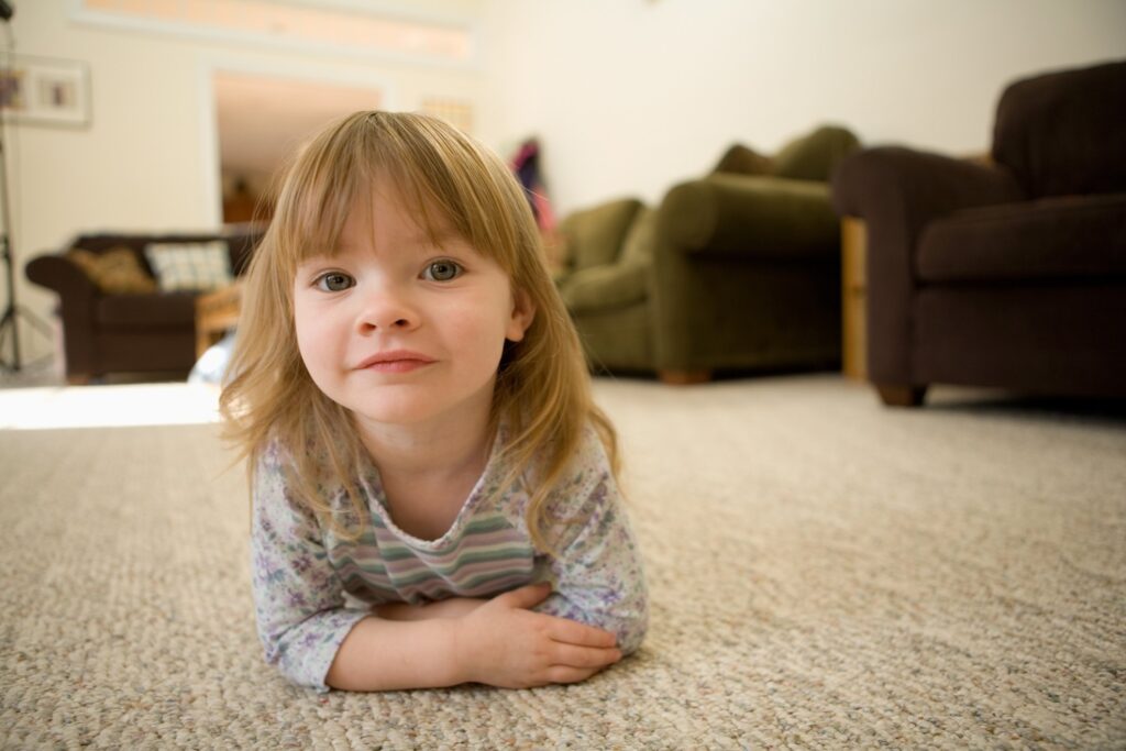 photo of a young girl on a heated carpet floor